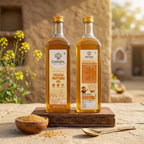 Two 1 litre bottles of Chahal Agri Farms wood-pressed yellow mustard oil on a wooden board with a bowl of mustard seeds