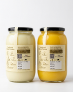 One litre jars of Chahal Agri Farms buffalo ghee (pale cream) and desi cow ghee (golden) side by side, showing the natural colour difference
